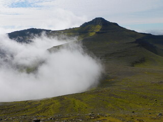 Fototapeta na wymiar Hiking and sailing around the coast and green mountains of the Faroe Islands