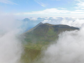 Hiking and sailing around the coast and green mountains of the Faroe Islands