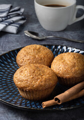 Carrot sweet muffins. Carrot cupcakes with sugar and cinnamon on a dark background