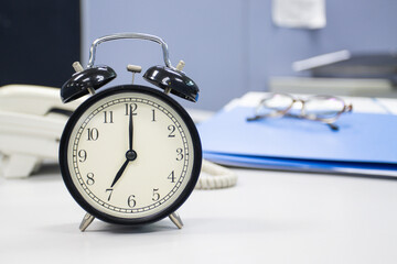 the clock on work desk in the office Time of businessman working concepts