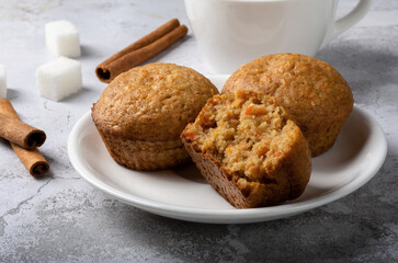 Carrot sweet muffins. Carrot cupcakes with sugar and cinnamon on a light background