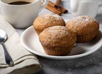 Carrot sweet muffins. Carrot cupcakes with sugar and cinnamon on a light background