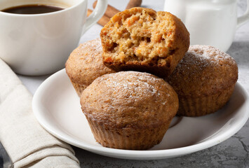 Carrot sweet muffins. Carrot cupcakes with sugar and cinnamon on a light background