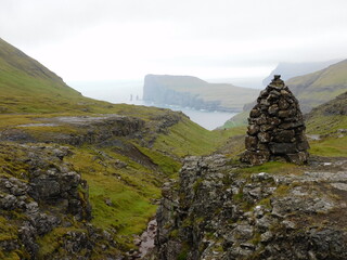 Exploring the green and lush Atlantic Coastline of the Faroe Islands in the Nordics