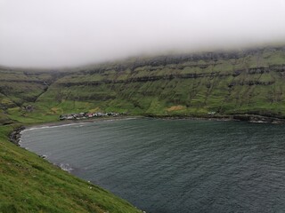 Dramatic cliffs, mountains and coastline on the lush Faroe Islands in the Atlantic Ocean