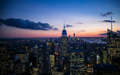 New York City. Manhattan downtown skyline with illuminated Empire State Building and skyscrapers at dusk. High quality photo