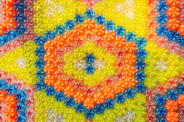Full frame colorful recycled PET bottles in flower pattern.