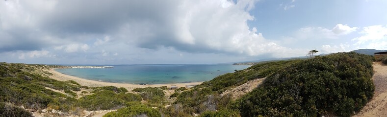 Panoramic view on Lara Beach, Cyprus from above. Hidden gem, not spoiled by tourists. Solitude, calm feelings, waves gently spreading on the beach. turquoise color of the water. Turtle hatching beach