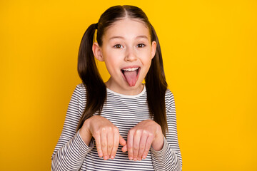 Photo of young girl happy positive smile grimace tongue-out hold hands dog isolated over yellow color background - obrazy, fototapety, plakaty