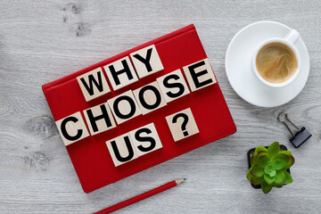 Why choose us? text on wood cubes on red notepad