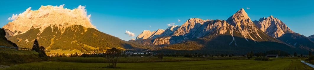 High resolution stitched panorama of a beautiful alpine sunset view with the famous Zugspitze and...