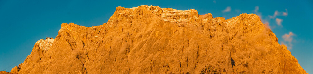 High resolution stitched panorama of a beautiful alpine sunset view of the famous Zugspitze summit...