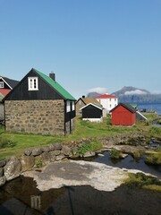 The cute and cozy old historical houses of the Faroe Islands with grass on the roof