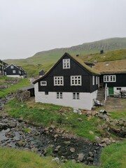 The cute and cozy old historical houses of the Faroe Islands with grass on the roof