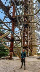 A young man standing under the Secret Soviet Radar 'DUGA-1', called a woodpecker hidden in the...