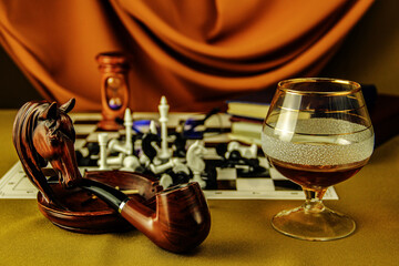 still life with glass of brandy tobacco pipe chess ashtray and books