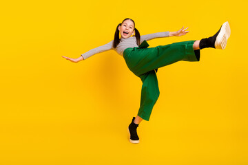 Low angle view full size profile side photo of young excited girl happy positive smile balance...