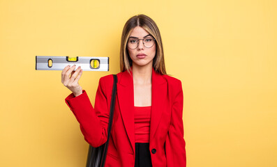 architect woman feeling sad and whiney with an unhappy look and crying and holding a level balance