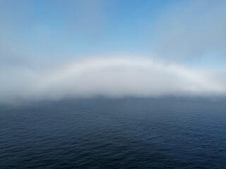 A rainbow over the Atlantic Ocean by the cliffs of Faroe Islands