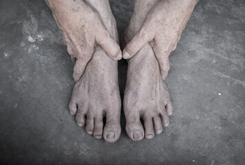 Asian elder man’s hands and feet. Concept of joint health and care, and aging skin.