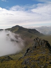 Stunning mountain views in the green and lush hills of the Faroe Islands in the Atlantic Sea