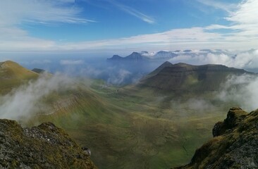 Stunning mountain views in the green and lush hills of the Faroe Islands in the Atlantic Sea