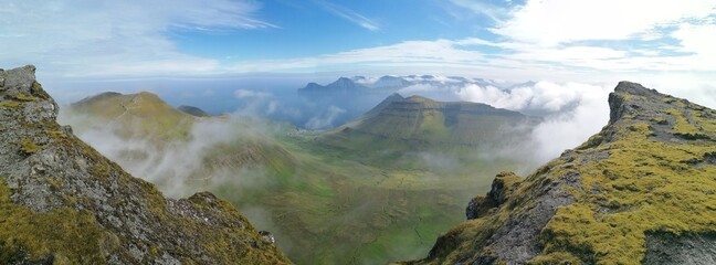 Obraz premium Stunning mountain views in the green and lush hills of the Faroe Islands in the Atlantic Sea