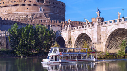 the cruise ship floats on the river against the background of the bridge with sculptures of angels...