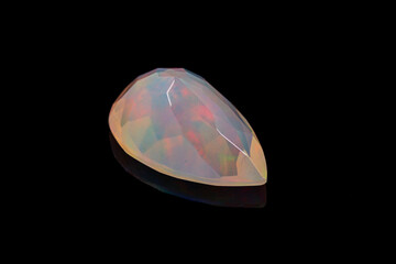macro mineral stone faceted opal on a black background