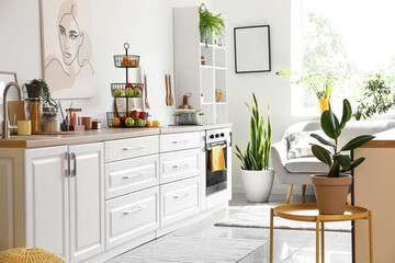 Interior of light kitchen with white counters and healthy food