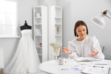 Female wedding planner working in office