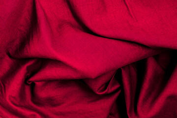 Close up top view of folded red cloth with texture for fabric background