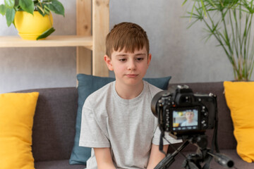 Teenage boy Vlogger records content for his blog. Child records the video on digital camera.