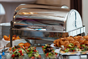 A beautiful buffet table with a hot warmer. Business meetings and celebrations.