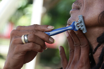 shave the beard with a razor