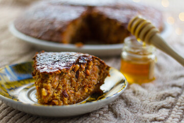 Cake piece with honey in background