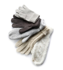 Fototapeta na wymiar Different warm gloves and mittens on white background