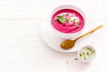 Cream soup made of red beet roots with basil