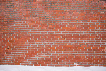wall background outdoor with red bricks and snow ground