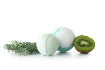 Bath bombs, fir branch and kiwi on white background