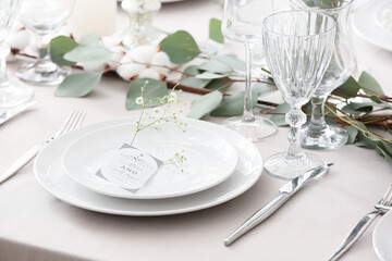 Beautiful table setting with wedding invitation and gypsophila flowers