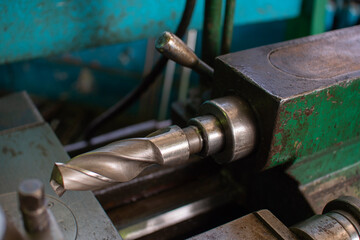 Old lathe 16K20 with a clamped drill.