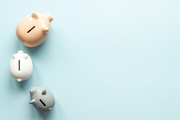 Many piggy bank - different types of currency saving and investments