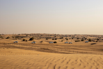 Safari with jeeps in sand dunes. Orange desert sand landscape