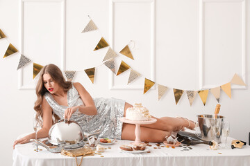 Obraz premium Drunk young woman after party lying on table