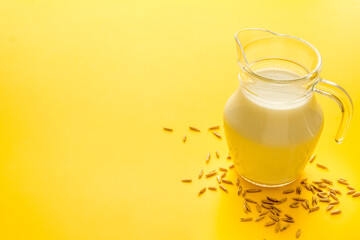Non dairy vegan milk in glass jar with ingredients, close up