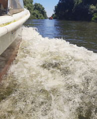 Details with the surf created by a moving small boat on a channel in Danube Delta.