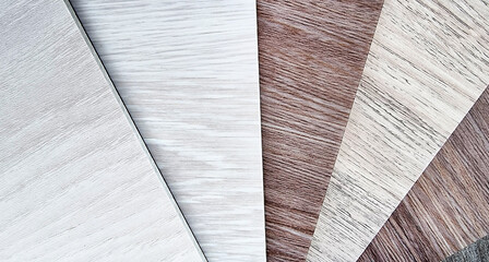 sample catalog of luxury vinyl laminate flooring tiles in saturated light color tone. close up multi color of wooden pvc vinyl tiles catalog. stacked of clean tone of vinyl floor tiles for selection.