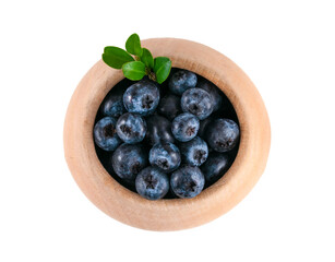 A small wooden bowl with berries on a white background
