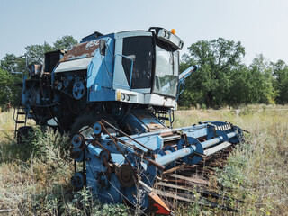 Old combine harvester abandoned in the field.